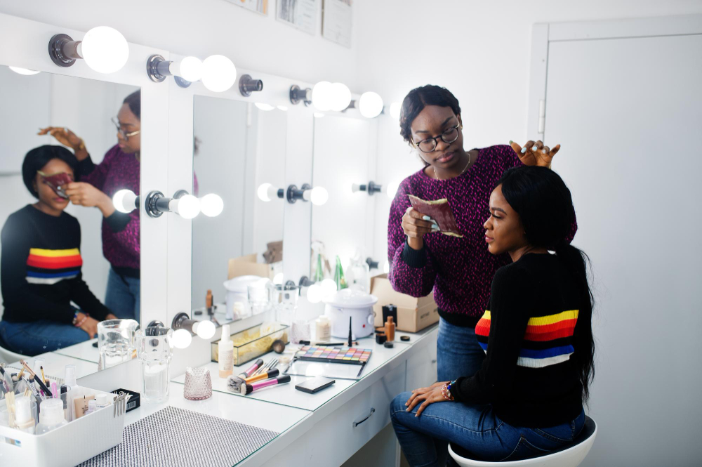 african-american-woman-applying-makeup-by-makeup-artist-beauty-saloon (1)