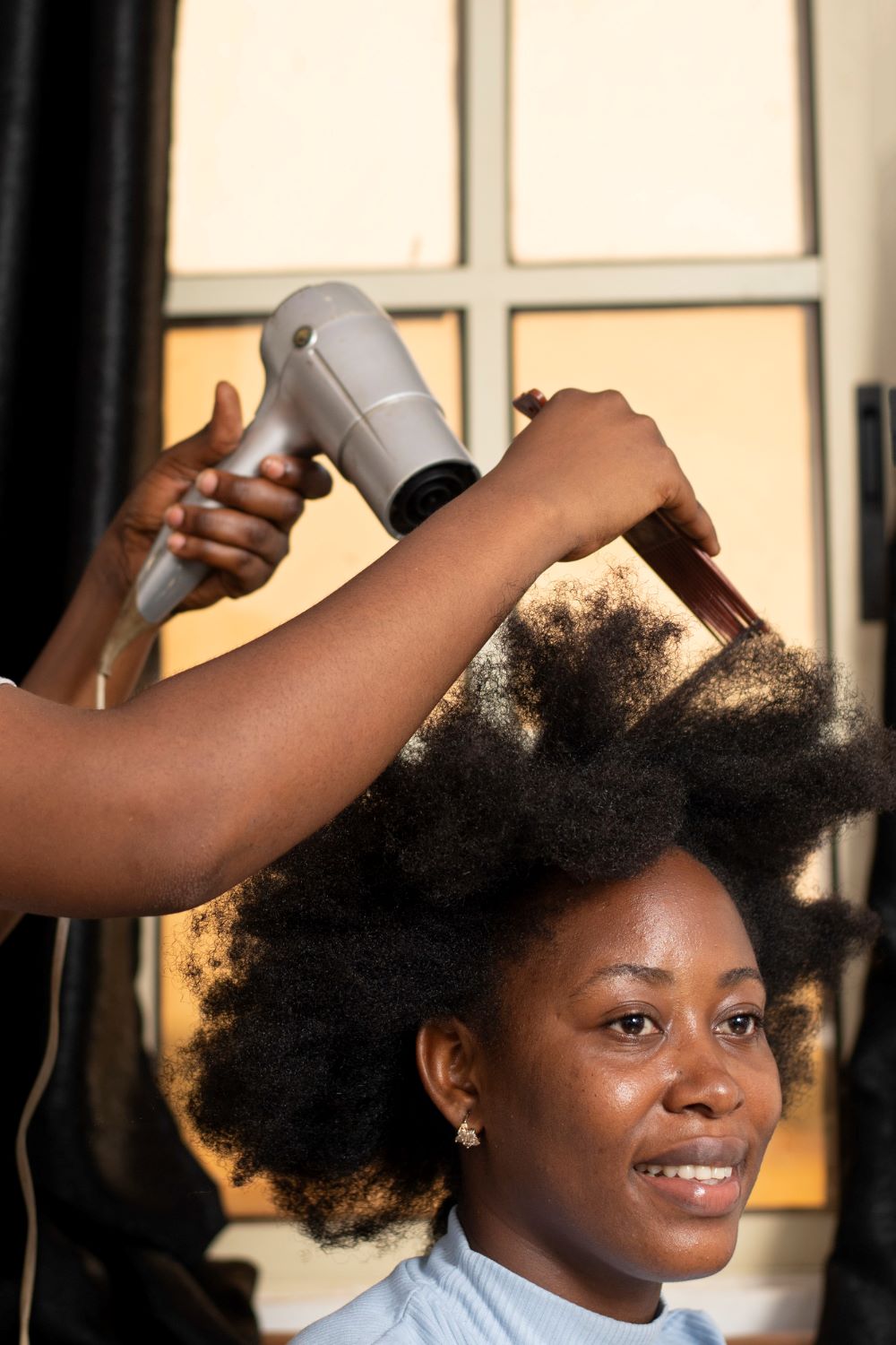 stylist-woman-taking-care-her-client-afro-hair (1)